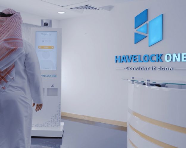 Still from Covid Defender video / employee interacts with display and Havelock One reception